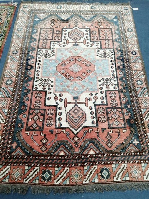 A Persian rug with central geometric medallion, 194 x 137cm